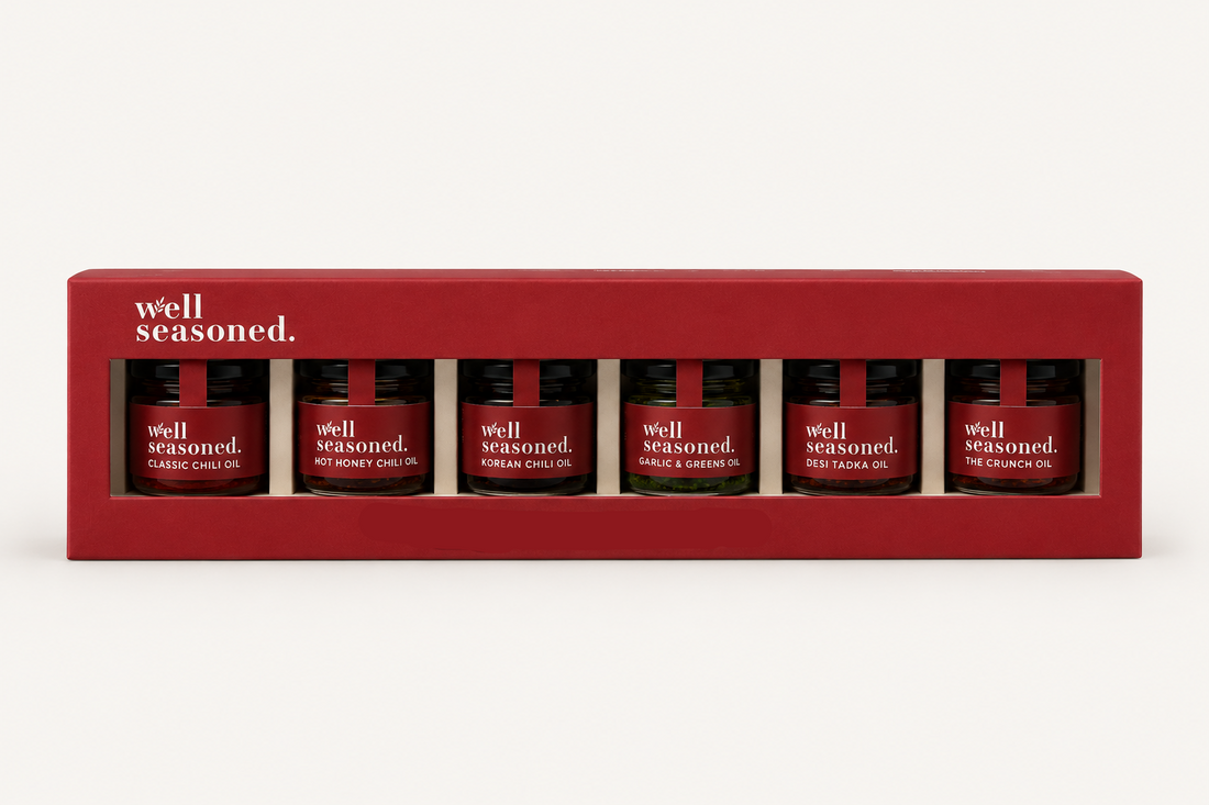Box of 'well seasoned' mini oil bottles on a white background